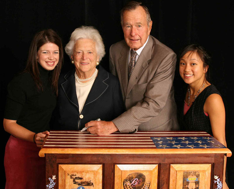 President George W Bush, his wife Barbara, and two representatives from Naomi's Hope nonprofit in Washington DC (the source of the image)